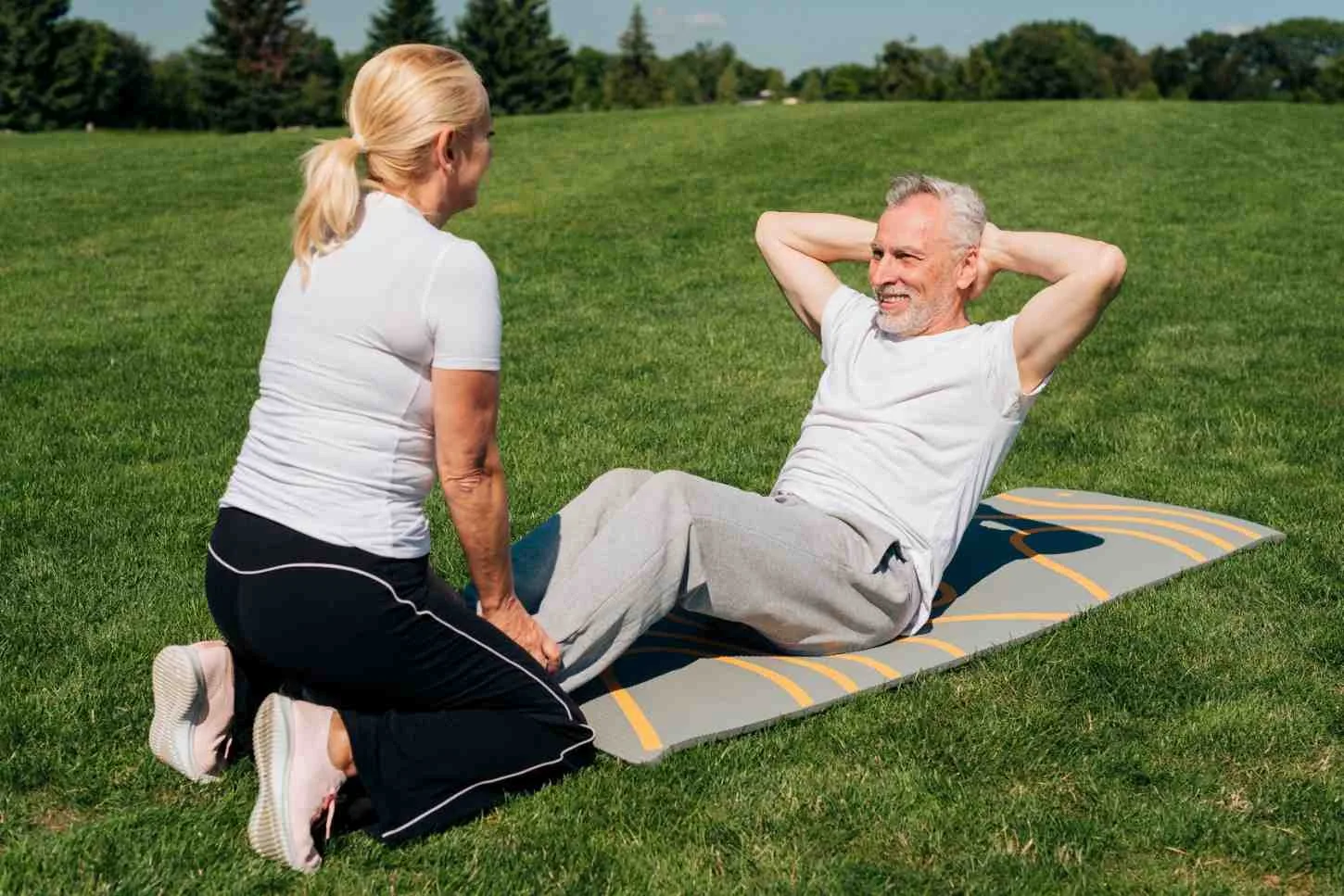 man-doing-crunches-being-held-by-woman (1)