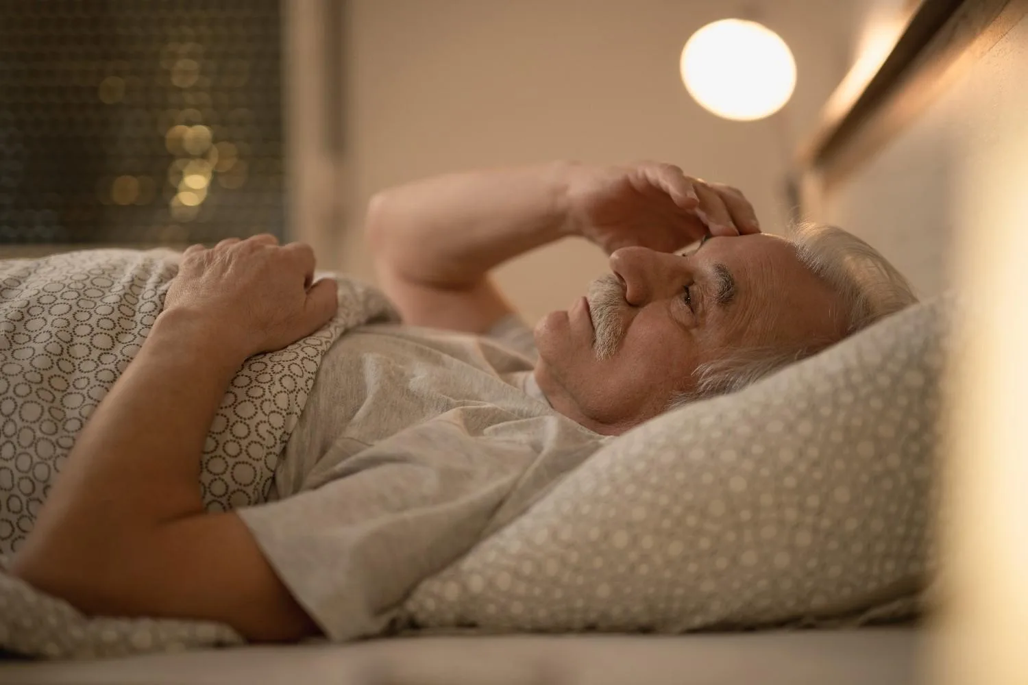 worried-senior-man-thinking-something-while-resting-bed-night (1)